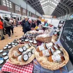 Des pots de soupe Perard sont présentés dans des paniers en osier, prêts à être dégustés lors d'une fête du terroir.