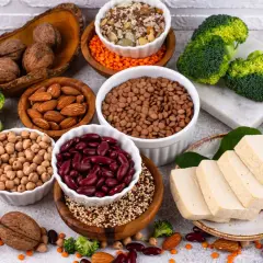 Un assortiment de protéines végétales : haricots rouges, lentilles, pois chiches, amandes, noix, tofu, brocolis et épinards. Le haricot rouge bienfait est un allié santé.